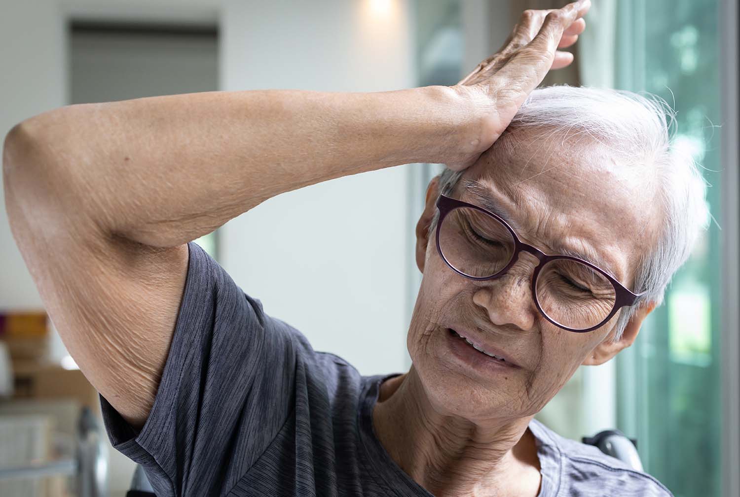 Senior woman suffering from severe headache,touch her temples,nerve pain in temples,old people with cerebrovascular disease,symptoms of stroke,problems of neurological,brain disorders in the elderly